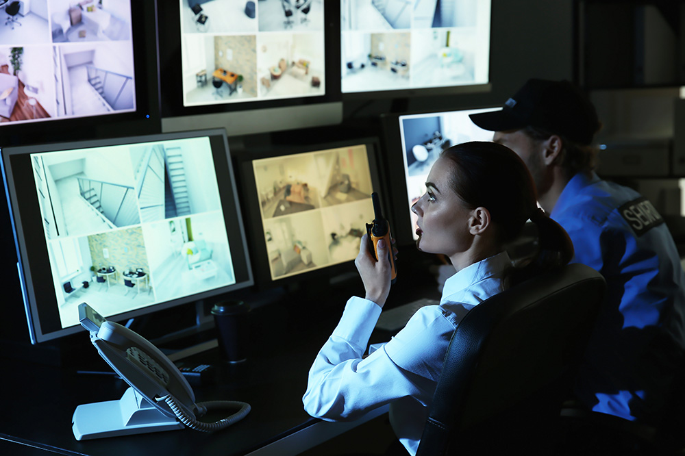Security guard monitoring modern CCTV
